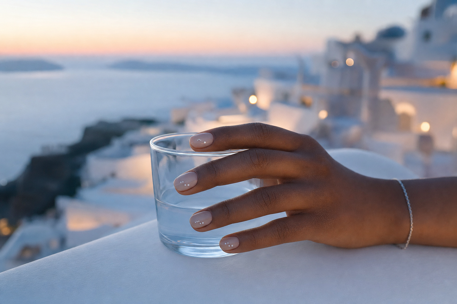 Minimal dotted manicure on a different hand during a Greek island evening