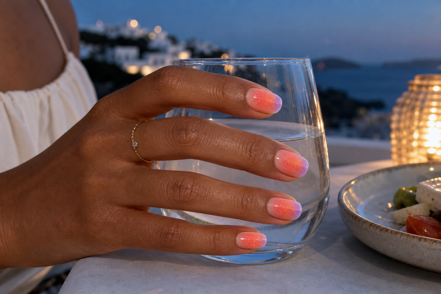 Sunset aura manicure on a different hand at an island dinner