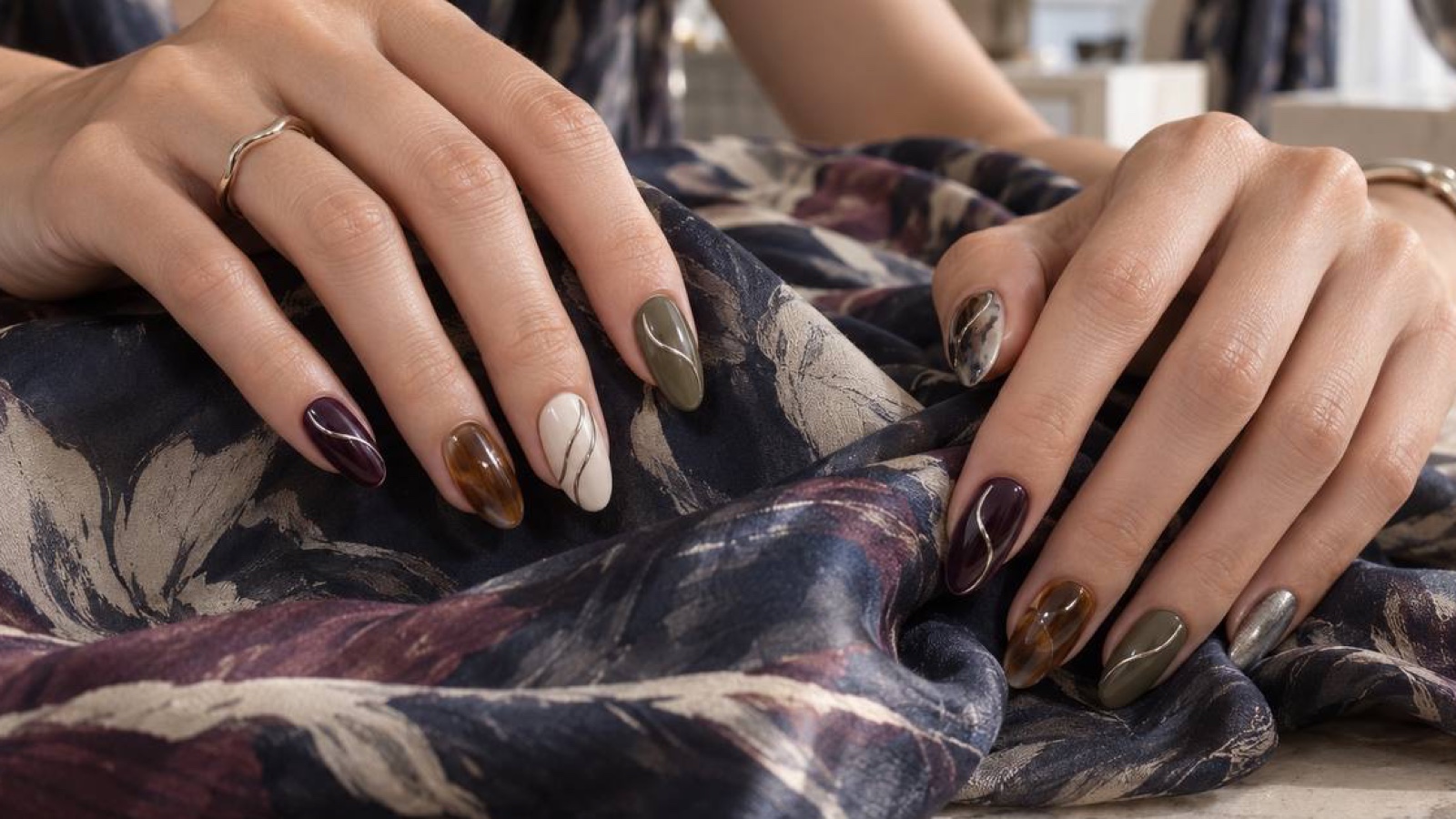 Omakase-style manicure composition with varied autumn colours and repeated line details